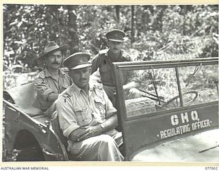 JACQUINOT BAY, NEW BRITAIN. 1944-11-18. OFFICERS OF THE UNIT IN THEIR JEEP AT THE 8TH MOVEMENT CONTROL GROUP (JACQUINOT BAY DETACHMENT) PALMALMAL PLANTATION. IDENTIFIED PERSONNEL ARE: QX6004 ..