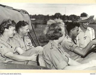 LAE AREA, NEW GUINEA. 1944-11-06. ALL AUSTRALIAN ARMY MEDICAL WOMEN'S SERVICE LEAVING THE GROUNDS OF 2/7 GENERAL HOSPITAL ARE REQUIRED TO HAVE AN ARMED ESCORT. CORPORAL H.G. WATSON, MILITARY ..