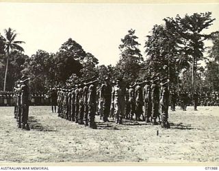 LAE, NEW GUINEA. 1944-04-02. MAJOR GENERAL B.M. MORRIS, DSO (1), GENERAL OFFICER COMMANDING AUSTRALIAN NEW GUINEA ADMINISTRATIVE UNIT, ACCOMPANIED BY QX59206 LIEUTENANT R.F. GORSCH (2), INSPECTS A ..