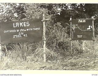 FINSCHHAFEN AREA, NEW GUINEA. 1944-03-13. ONE OF MANY BATTLE SIGNS IN THE FINSCHHAFEN AREA, THIS SIGN AT THE LAKES AREA RECORDS ACTIVITIES OF THE 2/43RD AND 2/32ND INFANTRY BATTALIONS
