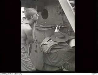 AT SEA IN THE ADMIRALTY ISLANDS AREA. 1944-03-08. LEADING AIRCRAFTMAN A. K. GOUGH, LAUNCESTON, TAS, HAS HIS MORNING SHAVE ON THE DECK OF A SHIP TAKING RAAF REINFORCEMENTS TO THE ADMIRALTY ISLANDS
