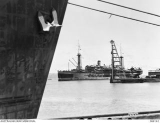 TOWNSVILLE, QUEENSLAND, AUSTRALIA. 1944-01-28. THE TROOPSHIP, "VAN HEUTSZ" PASSING THE BREAKWATER AS SHE COMES IN TO BERTH, WITH TROOPS OF THE 24TH INFANTRY BRIGADE ABOARD. THIS UNIT HAS HAD MANY ..