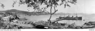 Port Moresby, Papua. 1942-08. A view from the township area looking across the harbour and surrounding hills with an anti aircraft crew and gun in the foreground