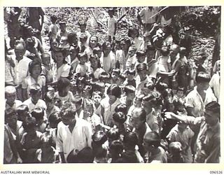 RABAUL AREA, NEW BRITAIN. 1945-09-13. CHINESE CIVILIANS, INTERNED BY THE JAPANESE AT A CAMP 15 MILES WEST OF RABAUL, WERE CONTACTED BY A PARTY OF AUSTRALIAN ARMY AND RED CROSS OFFICIALS SOON AFTER ..