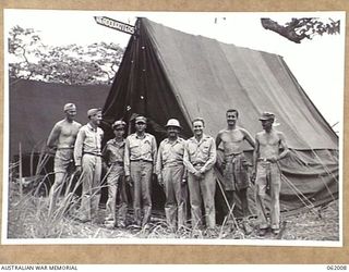 DREGER HARBOUR, NEW GUINEA. 1943-12-05. COMMANDING OFFICER AND OFFICERS OF THE 348TH UNITES STATES FIGHTER GROUP PHOTOGRAPHED IN FRONT OF THEIR GROUP HEADQUARTERS