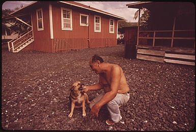 EUGENE KAUPIKO, 66, WAS BORN AND STILL LIVES IN THE REMOTE FISHING VILLAGE OF MILOLAII. A PLANNED SUBDIVISION ONE MILE AWAY NOW THREATENS THE SIMPLE LIFE OF THE VILLAGE. IN 1971 ITS ONLY APPROACH ROAD WAS PAVED FOR EASIER ACCESS TO THE DEVELOPMENT. MR. KAYPIKO RUNS A GENERAL STORE (RIGHT). HIS HOUSE IS ON THE LEFT