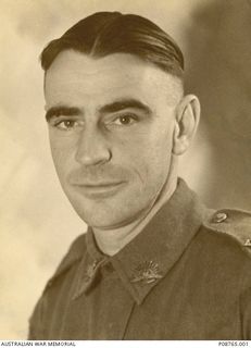 Studio portrait of NX26478 Private (Pte) Ernest Leslie Burgess, 8th Division Supply Column Mechanical Transport, of Picton, NSW. A typewriter mechanic and truck driver prior to his enlistment on 19 ..