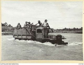 1943-09-20. NEW GUINEA. BUSO RIVER - LAE AREA. A HEAVY ARMY TRUCK FORDS THE SWIFTLY FLOWUNG BUSO RIVER. (NEGATIVE BY H. DICK)