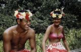 French Polynesia, man and woman wearing Tahitian flower crowns