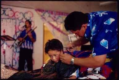 Kayne Lucas Upokokeu's hair is cropped short at his hair-cutting ceremony