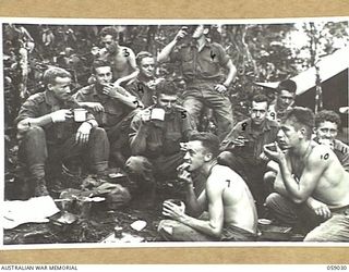 FARIA VALLEY, NEW GUINEA, 1943-10-17. LUNCHTIME FOR THE TROOPS OF "B" COMPANY, 2/16TH AUSTRALIAN INFANTRY BATTALION NEAR JOHN'S KNOLL. THEY ARE:- WX4241 ACTING SERGEANT W.T. MCMAHON, MM., (1); ..