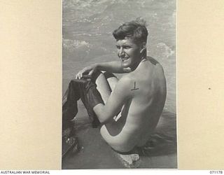 EVAPIA RIVER, NEW GUINEA, 1944-03-15. N53783 GUNNER F. ANDREWS, (1) OF THE 4TH FIELD REGIMENT, HAVING A GENERAL CLEAN UP IN THE EVAPIA RIVER NEAR KESAWAI. THE UNIT HAS RECENTLY ARRIVED FROM FORWARD ..