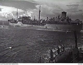 MILNE BAY, PAPUA. THE US TANKER PUEBLO, AGROUND ON DORISAI SHOAL, BEING TOWED OFF BY THE CORVETTE HMAS BROOME. (NAVAL HISTORICAL COLLECTION)