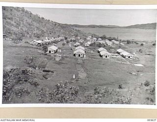 PORT MORESBY - SEVEN HUTS NEAREST CAMERA ARE PORTION OF NEW RAAF CAMP THEN IN COURSE OF ERECTION AT KONEDOBU, NEAR PORT MORESBY, HUTS IN DISTANCE THEN NEW MILITARY CAMP. OTHERS ORIGINALLY BELONGED ..