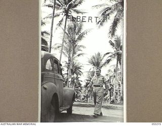 MILNE BAY, NEW GUINEA. 1943-06-26. QX51027 CORPORAL J. BUTLER (IN CAR) AND QX37976 SERGEANT A.E. SMITH AT THE 5TH AUSTRALIAN DIVISION TRANSPORT PARK, (ALBERT PARK)