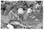 Women making baskets for food from the earth ovens.