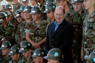 The Honorable Dr. Donald C. Winter (right), Secretary of the U.S. Navy (SECNAV), pose for a photograph with Seabees from the Naval Mobile Construction Battalion 40, during a meet and greet breakfast at Camp Covington Galley during his visit onboard Naval Base Guam on Aug. 25, 2006. The Seabees are currently deployed to Guam. They also have detachments deployed in Iraq and Afghanistan. (U.S. Navy photo by Mass Communication SPECIALIST 2nd Class John F. Looney (Released)