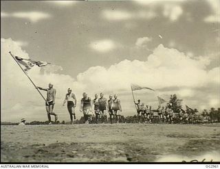 AITAPE, NORTHERN NEW GUINEA. C. 1945-09. THE GENERAL MARCH PAST OF RAAF AND AUSTRALIAN ARMY UNITS SURF LIFE-SAVING TEAMS AT THE CARNIVAL IN WHICH SOME TWENTY TEAMS COMPETED AND WAS WATCHED BY A ..