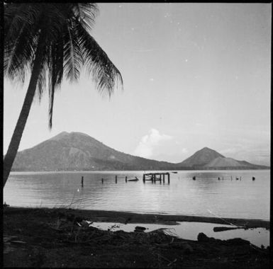 Mother and Daughter Mountains with a ruined jetty in the foreground, Rabaul Harbour, New Guinea, 1937 / Sarah Chinnery