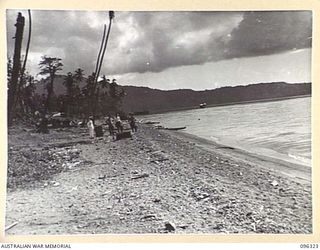 MALAGUNA MISSION, NEW BRITAIN. 1945-09-10. JAPANESE STAFF OFFICERS ON THE BEACH, WATCHING THE LANDING OF THE AUSTRALIAN OCCUPATION FORCE. TROOPS OF 4 INFANTRY BRIGADE OCCUPIED THE RABAUL AREA ..