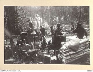 BOUGAINVILLE. 1945-04-06. MEMBERS OF HEADQUARTERS 15 INFANTRY BRIGADE (SIGNALS) UNLOADING EQUIPMENT AT THE NEW BRIGADE POSITION BESIDE THE TOKO-DARARA ROAD