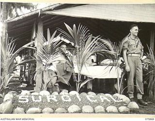 ALEXISHAFEN NORTH, NEW GUINEA. 1944-09-01. THE ENTRANCE TO THE NEW SURGICAL WARD AT THE MEDICAL DRESSING STATION OF THE 2/15TH FIELD AMBULANCE. IDENTIFIED PERSONNEL ARE:- QX30627 PRIVATE C.G. ..