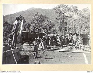 NANTAMBU, NEW BRITAIN, 1945-08-22. TROOPS OF C COMPANY, 37/52ND INFANTRY BATTALION UNLOADING GEAR FROM TRUCKS READY TO GO OUT TO A ROYAL NEW ZEALAND AIR FORCE CATALINA AIRCRAFT BY LAUNCH. THE ..