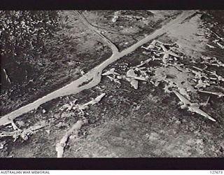 WEWAK, NEW GUINEA. 1944. "GRAVEYARD" OFF AIRSTRIP. TWO MORE "PARAFRAGS" CAN BE SEEN DROPPING (TOP CENTRE)