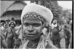 Adolescent wearing marsupial fur headdress, shell valuables, and beaded necklace