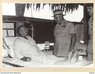 NADZAB, NEW GUINEA. 1945-10-25. GENERAL SIR THOMAS A. BLAMEY, COMMANDER-IN-CHIEF, ALLIED LAND FORCES, SOUTH WEST PACIFIC AREA, SPEAKING TO MAJOR E.J. BARKE, A PATIENT AT 2/7 GENERAL HOSPITAL. ..