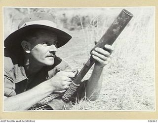 PAPUA, NEW GUINEA. 1942-09-07. A TYPE-89 JAPANESE GRENADE THROWER, OR DISCHARGER, FOR TWO-INCH GRENADES. AS SHOWN IN THE PHOTOGRAPH IT HAS TO BE HELD BY THE LEFT HAND AND PRESSED FIRMLY INTO THE ..