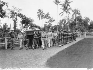 SOPUTA, NEW GUINEA. 1943-09-29. THE FIRING PARTY SALUTES AS THE COFFIN AND PALL BEARERS PASS THROUGH THEIR RANKS DURING THE FUNERAL OF BRIGADIER (BRIG) R. B. SUTHERLAND. THE PALL BEARERS ARE: VX289 ..