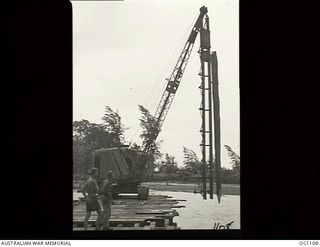 AITAPE, NORTH EAST NEW GUINEA. C. 1944-06. A PILE DRIVER SWINGING A PILE INTO POSITION OVER A BRIDGE AT AITAPE