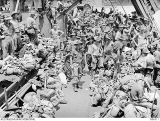 CUTARP PLANTATION, JACQUINOT BAY, NEW BRITAIN. 1944-12-15. 19 INFANTRY BATTALION TROOPS ON THE DECK OF THE TROOPSHIP FRANCIS PARKMAN AWAITING THE ORDER TO GO ASHORE