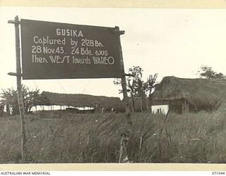 GUSIKA, FINSCHHAFEN AREA, NEW GUINEA. 1944-03-13. ONE OF MANY BATTLE SIGNS IN THE FINSCHHAFEN AREA, THIS SIGN RECORDS ACTIVITIES OF THE 2/28TH INFANTRY BATTALION