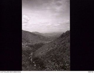 KILOGI VALLEY, NEW GUINEA. 1943-10-26. THE VALLEY FROM THE 23 MILE POINT, LOOKING IN THE DIRECTION OF PORT MORESBY. THE BUILDINGS ON THE LEFT CENTRE, COMPRISE THORPEVILLE, AN AUSTRALIAN ..