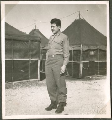 Soldier in front of tents
