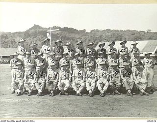 Group portrait of thirty four personnel of the 18th Field Ambulance on the unit parade ground. Identified, back row, left to right: Sergeant (Sgt) F T Gray; Sgt J Malyon; Private (Pte) J ..