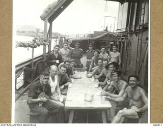 NEW GUINEA. 1944-06-15. MEMBERS OF THE ORIGINAL CREW OF THE AB442 12TH WATER TRANSPORT OPERATING COMPANY, WHO BROUGHT THE VESSEL FROM SYDNEY TO NEW GUINEA ARE SHOWN RELAXING AT THE CONCLUSION OF ..