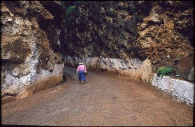 Person walking along road, Mangaia