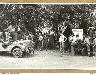 COCONUT BEACH, NEW GUINEA. 1943-12-28. THIRSTY SOLDIERS ENJOY A DRINK OF COFFEE AT THE YOUNG MEN'S CHRISTIAN ASSOCIATION HUT AT THE BEACH