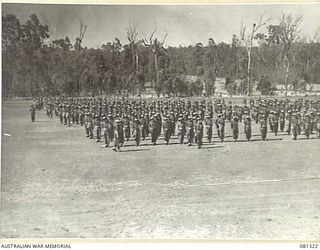 HERBERTON, QUEENSLAND, AUSTRALIA. 1944-10-11. TROOPS OF THE 2/ 4TH INFANTRY BATTALION AWAIT THE ARRIVAL OF VX17 MAJOR GENERAL J.E.S. STEVENS, DSO, ED, GOC 6TH DIVISION, TO MAKE A PRESENTATION OF ..