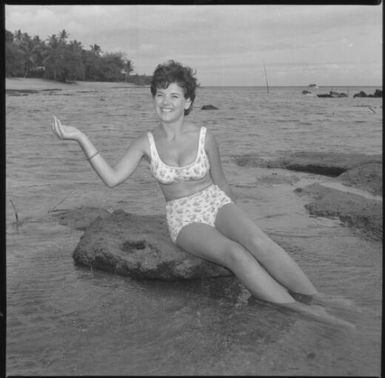 Miss Maglia wearing a bikini and sitting on a rock in the sea at Suva, Fiji, 22 February 1966 [2] John Mulligan