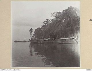 JACQUINOT BAY, NEW BRITAIN. 1945-04-12. BARGES AWAITING REPAIR LINE THE BANKS OF THE CAMP AREA, 3016 ENGINEER BOAT MAINTENANCE COMPANY (US ARMY), ATTACHED 5 DIVISION. THEY WILL RETURN TO THE ..