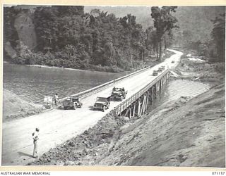 MAPE RIVER, NEW GUINEA, 1944-03-15. THE NO.1 TWO WAY PILE- BENT 340 FOOT BRIDGE OVER THE MAPE RIVER ON THE CULLINS ROAD, LINKING DREGER HARBOUR AND FINSCHHAFEN. THE ROAD IS NAMED AFTER THE LATE ..