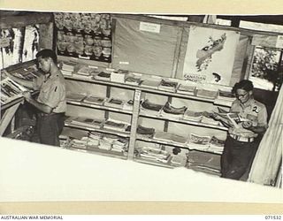 KOITAKI, PORT MORESBY AREA, NEW GUINEA. 1944-03-27. THE MAGAZINE SECTION OF THE AUSTRALIAN ARMY EDUCATION SERVICE LIBRARY ATTACHED TO THE 113TH CONVALESCENT DEPOT BEING USED BY MEMBERS OF THE UNIT. ..