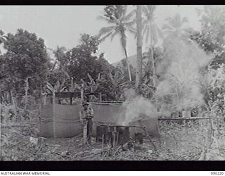 GOODENOUGH ISLAND, NEW GUINEA, 1942-10. IMITATION KITCHENS, WITH FIRES CONTINUOUSLY BURNING, WERE PART OF THE BLUFF AND DECEPTION PRACTISED BY A SMALL FORCE OF AUSTRALIANS WHO SEIZED THE ISLAND AND ..