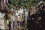 Group of men around a shell money payment, probably a bride price wa'i payment