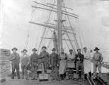 Crew of three-masted bark HESPER standing on wharf in front of ship, Washington State, between 1892 and 1906
