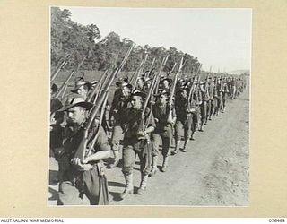 LAE, NEW GUINEA. 1944-10-07. A MARCH PAST OF THE 2/8TH COMMANDO SQUADRON.. IDENTIFIED PERSONNEL ARE:- TROOPER K. O'KEEFE (1); TROOPER L. EDWARDS (2); TROOPER J. BROOKE (3); TROOPER H.W. LACEY (4); ..